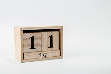 Wooden calendar May 11 on a white background