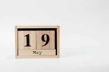 Wooden calendar May 19 on a white background