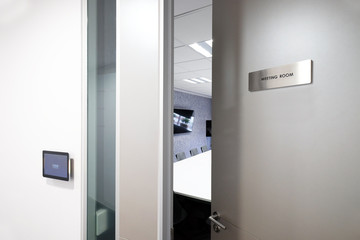 Door with knob opening to the meeting room, with status monitoring and controlling electronic...