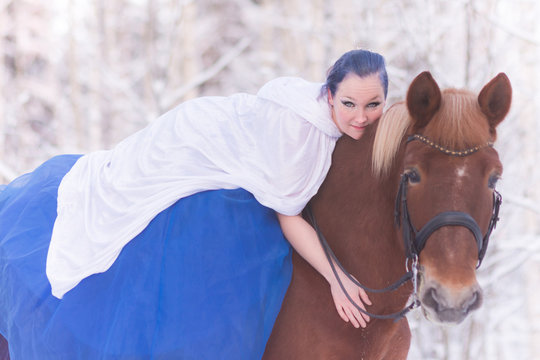 Lady in blue in midst of finnish winter forest