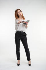 Attractive visagist or korean make-up artist holding a makeup brushes and a palette of eye shadow on white background