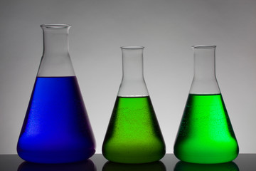 Liquid in laboratory bottles. Scientific biochemical laboratory. Colorful liquid.