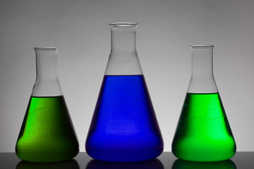 Liquid in laboratory bottles. Scientific biochemical laboratory. Colorful liquid.