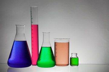 Liquid in laboratory bottles. Scientific biochemical laboratory. Colorful liquid.