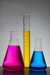 Liquid in laboratory bottles. Scientific biochemical laboratory. Colorful liquid.