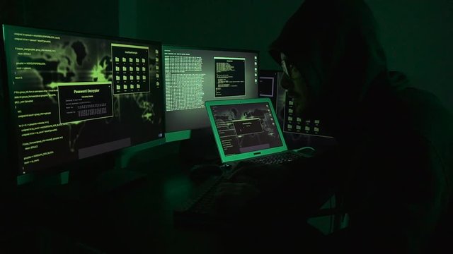 young hacker man programmer in his black digital business work. network online data attack for web server office database. dark internet software screen computer in background. modern working system