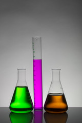Liquid in laboratory bottles. Scientific biochemical laboratory. Colorful liquid.