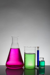 Liquid in laboratory bottles. Scientific biochemical laboratory. Colorful liquid.