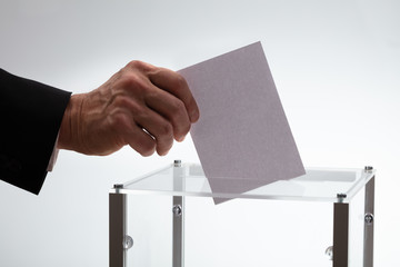 Businessman Inserting Ballot In Box