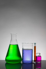 Liquid in laboratory bottles. Scientific biochemical laboratory. Colorful liquid.