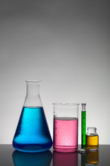 Liquid in laboratory bottles. Scientific biochemical laboratory. Colorful liquid.