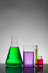 Liquid in laboratory bottles. Scientific biochemical laboratory. Colorful liquid.