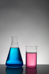 Liquid in laboratory bottles. Scientific biochemical laboratory. Colorful liquid.
