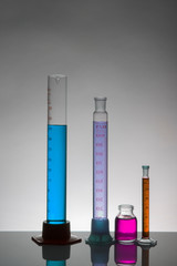 Liquid in laboratory bottles. Scientific biochemical laboratory. Colorful liquid.