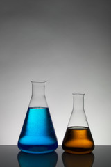 Liquid in laboratory bottles. Scientific biochemical laboratory. Colorful liquid.