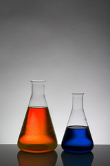 Liquid in laboratory bottles. Scientific biochemical laboratory. Colorful liquid.