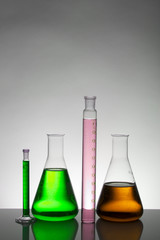 Liquid in laboratory bottles. Scientific biochemical laboratory. Colorful liquid.
