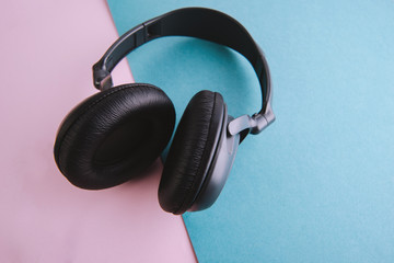 Photo of minimallist black headphones on blue, pink table