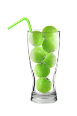 green apples in a glass, green cocktail tube, collage concept, isolated on white background