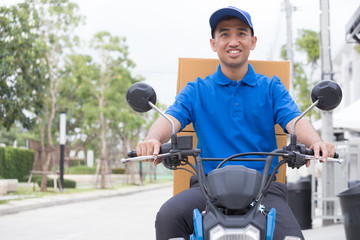 Delivery boy on motorcycle with trunk parcel box driving to fast in rush. Courier delivering order online. Express delivery within specified time by scooter concept