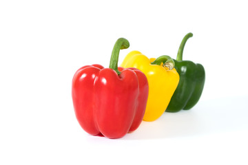 Red, yellow, green fresh and healthy peppers on white background