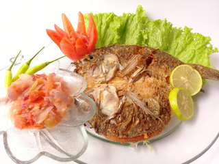 Tropical fried fish recipe on plate