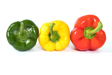 Red, yellow, green fresh and healthy peppers on white background