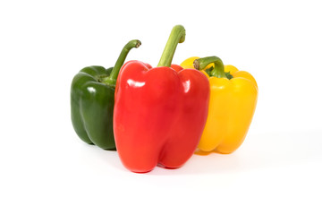 Red, yellow, green fresh and healthy peppers on white background