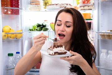 Close-up Of A Woman Eating Cake