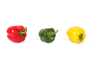 Red, yellow, green fresh and healthy peppers on white background