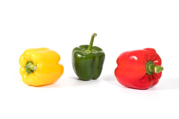 Red, yellow, green fresh and healthy peppers on white background
