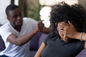 Tired frustrated african wife ignoring angry black despot husband arguing blaming upset woman of...