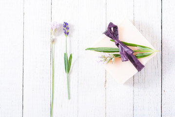 soap bar and lavender flowers on white wood table background