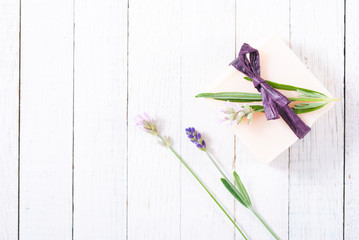 soap bar and lavender flowers on white wood table background