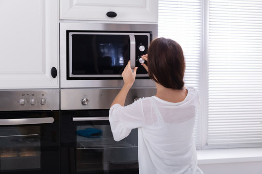 Woman Using Microwave Oven