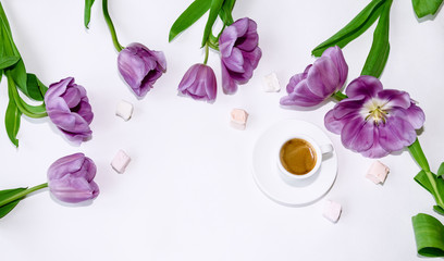 cup of coffee and flowers of beautiful tulips on a light background
