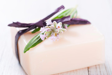 Obraz na płótnie Canvas soap bar and lavender flowers on white wood table background