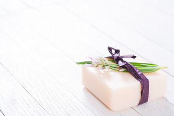 soap bar and lavender flowers on white wood table background
