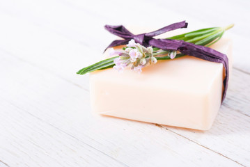 soap bar and lavender flowers on white wood table background