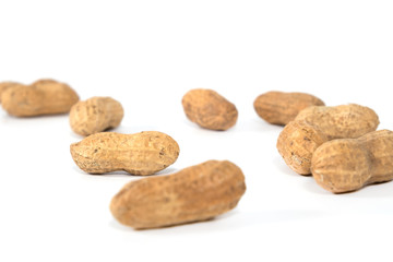 Raw tasty peanuts on white background