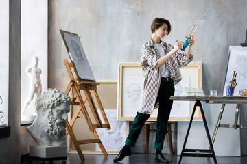 Modern creative artist sculptor woman female creator student at art studio workshop workplace...