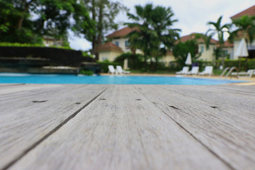 Old wooden floor, blurred background, swimming pool in the house area