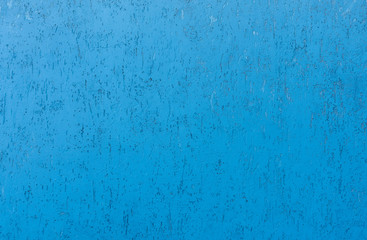 textured blue plastered wall with cracks and pits