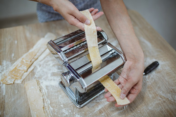 Housewife makes noodles with a special device. New generation