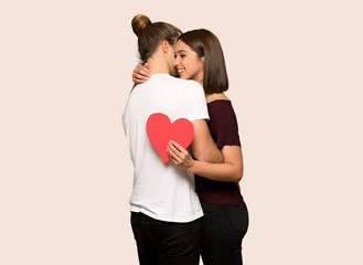 Fototapeta na wymiar Couple in valentine day hugging and with a rose over isolated background