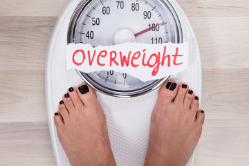 Woman Standing On Weighing Scale