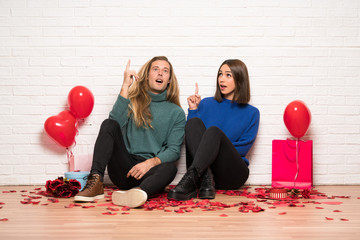 Couple in valentine day thinking an idea pointing the finger up