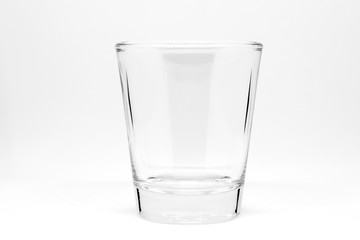 Empty small shot glass isolated on white background.