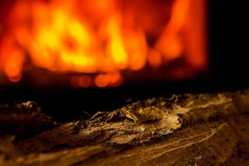 lit candle with fireplace fired up