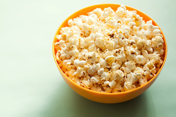 An orange bowl with popcorn isolated